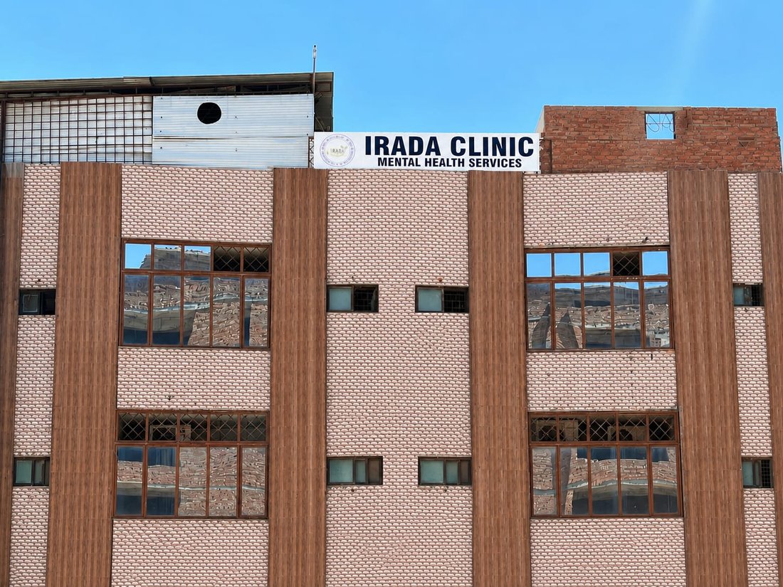The exterior of IRADA Clinic's building in Islamabad, with the IRADA Clinic Mental Health Services signage.